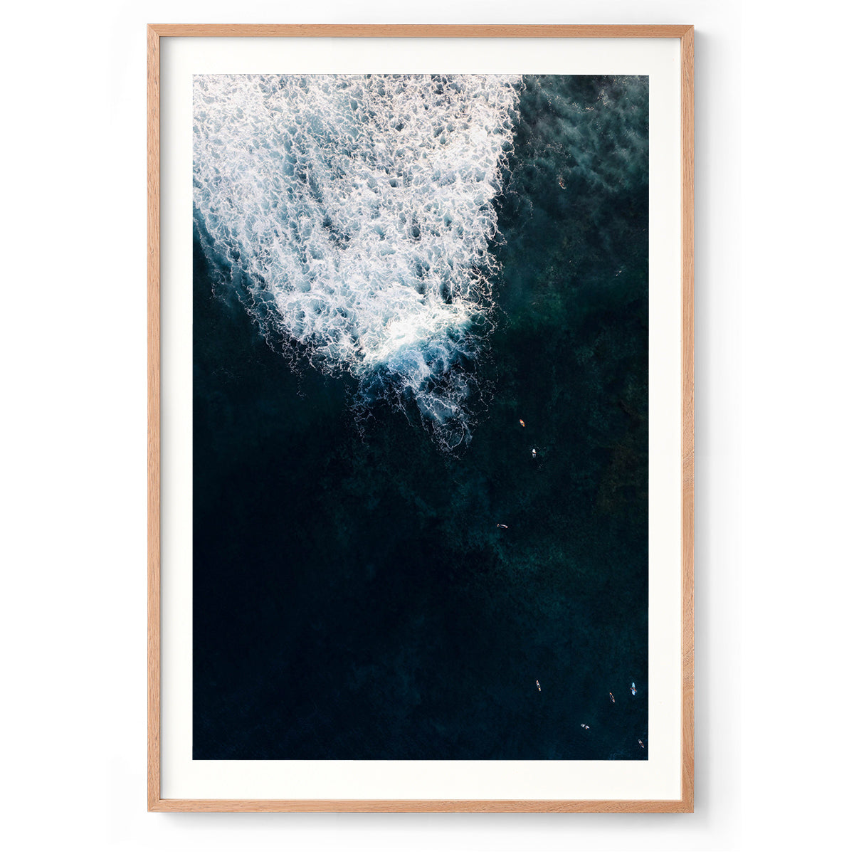Vertical aerial photo of surfers in deep blue water at Yallingup beach, Western Australia. Perfect for a coastal home or beach house. Original fine art photography, available as prints and framed wall art.