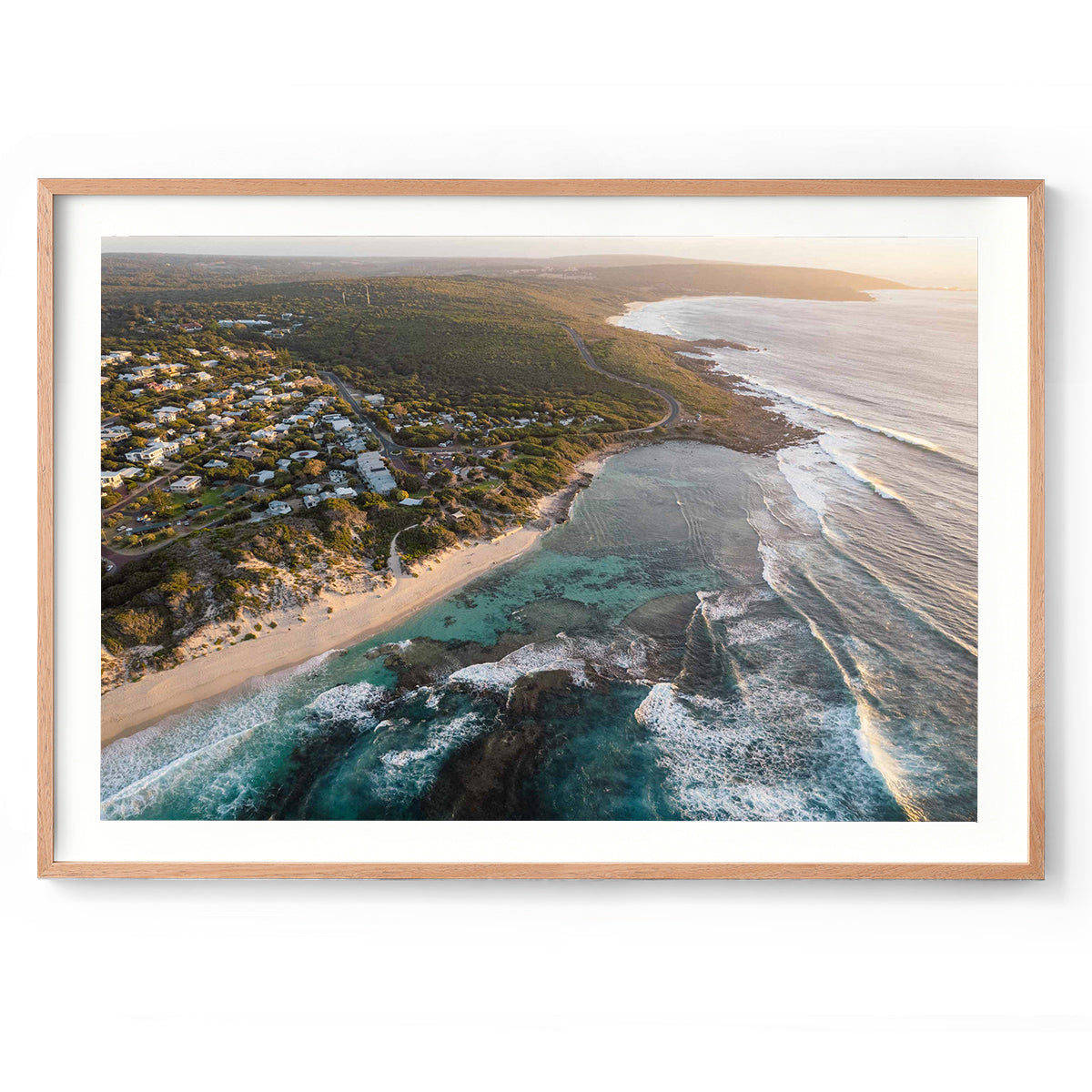 Horizontal drone photo of Yallingup beach and town in Western Australia, taken from above the ocean looking towards the south as the bush stretches into the distance. Original fine art photography, available as prints and framed wall art.