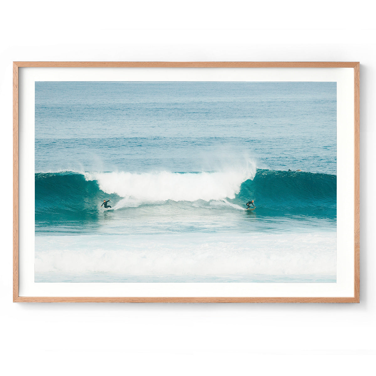 Photo of two surfers riding a wave in the ocean at Surfer's Point in Margaret River, Western Australia. Fine art prints, available framed in oak, black or white.