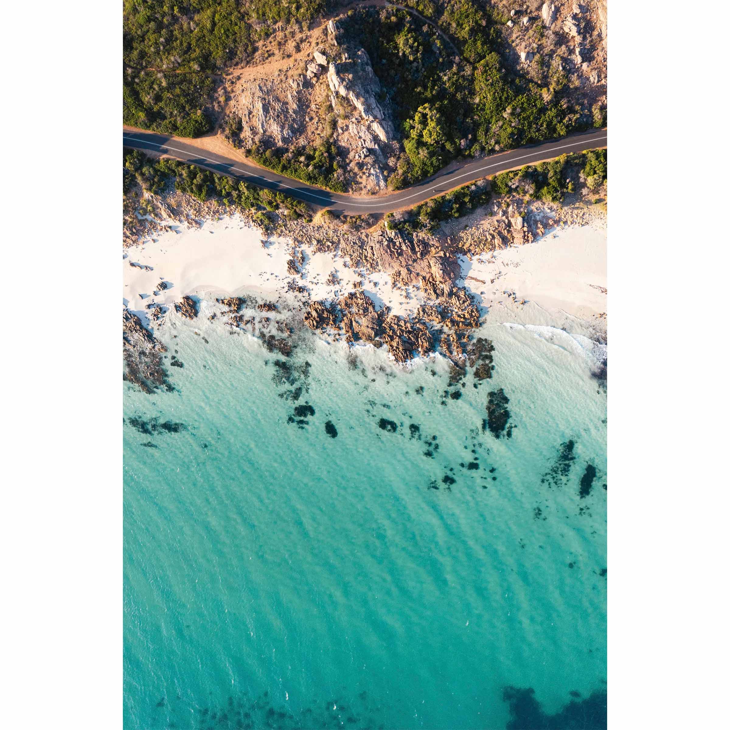 Vertical drone photo taken of the road between Meelup beach and Bunker Bay in Western Australia near Yallingup. The road curves softly between the white sandy beach of Eagle Bay and the bush. Perfect for the modern beach home, coastal interior or relaxed space. Original fine art photography, available as prints and framed wall art.