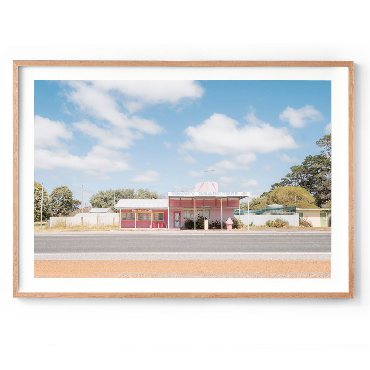 Horizontal photo of Tunney Roadhouse in Western Australia. Pink roadhouse with pastel blue skies and fluffy clouds. Original fine art photography, available as prints and framed wall art. Perfect for your living room, dining room, bedroom or home office. Shipped free worldwide.