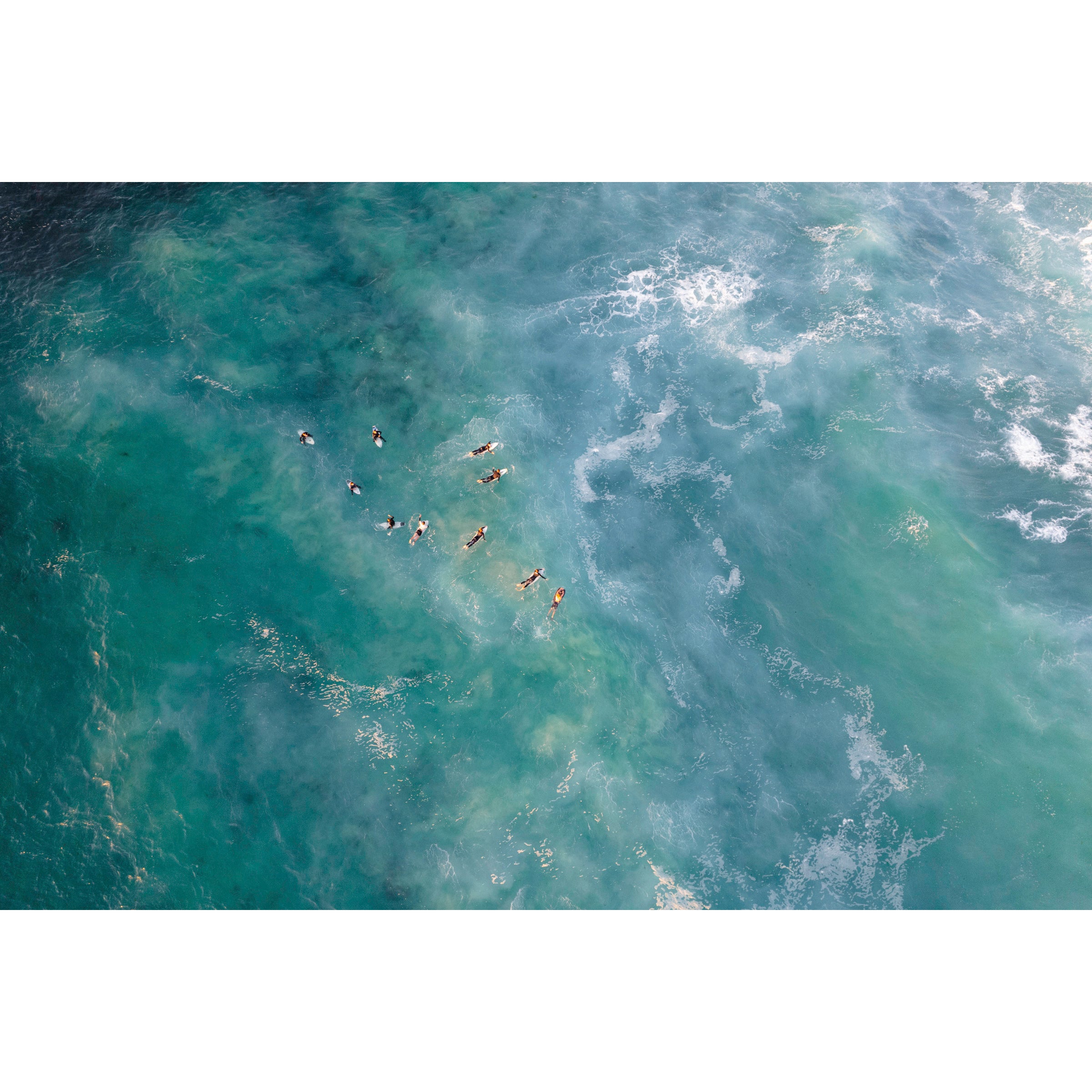 Horizontal drone photo of the ocean at Yallingup beach in Western Australia. Surfers wait for the waves to come in and are dotted all over the water. Original coastal fine art photography, available as prints and framed wall art. Perfect for your minimalist living room, dining room, bedroom or home office. Shipped free worldwide.