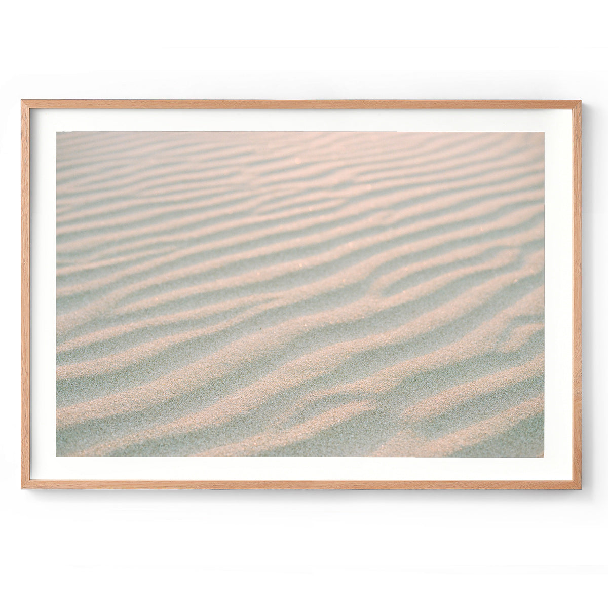 Horizontal close up photo of ripples of beach sand, with a golden glow from sunset. Perfect for the coastal home or beach house. Available as fine art photography prints and framed wall art.