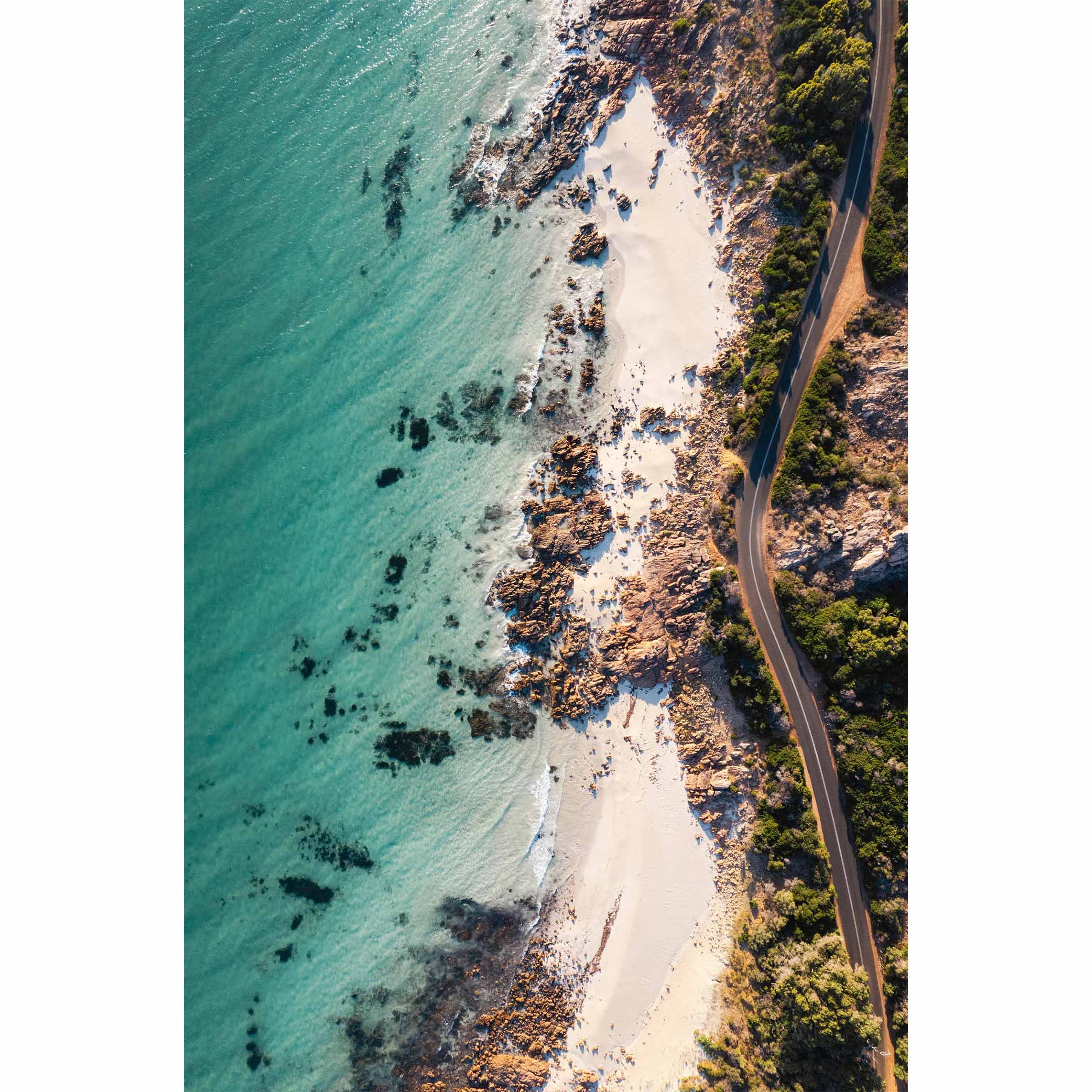 Vertical drone photo taken of the road between Meelup beach and Bunker Bay in Western Australia near Yallingup. The road curves softly between the white sandy beach of Eagle Bay and the bush. Perfect for the modern beach home, coastal interior or relaxed space. Original fine art photography, available as prints and framed wall art.