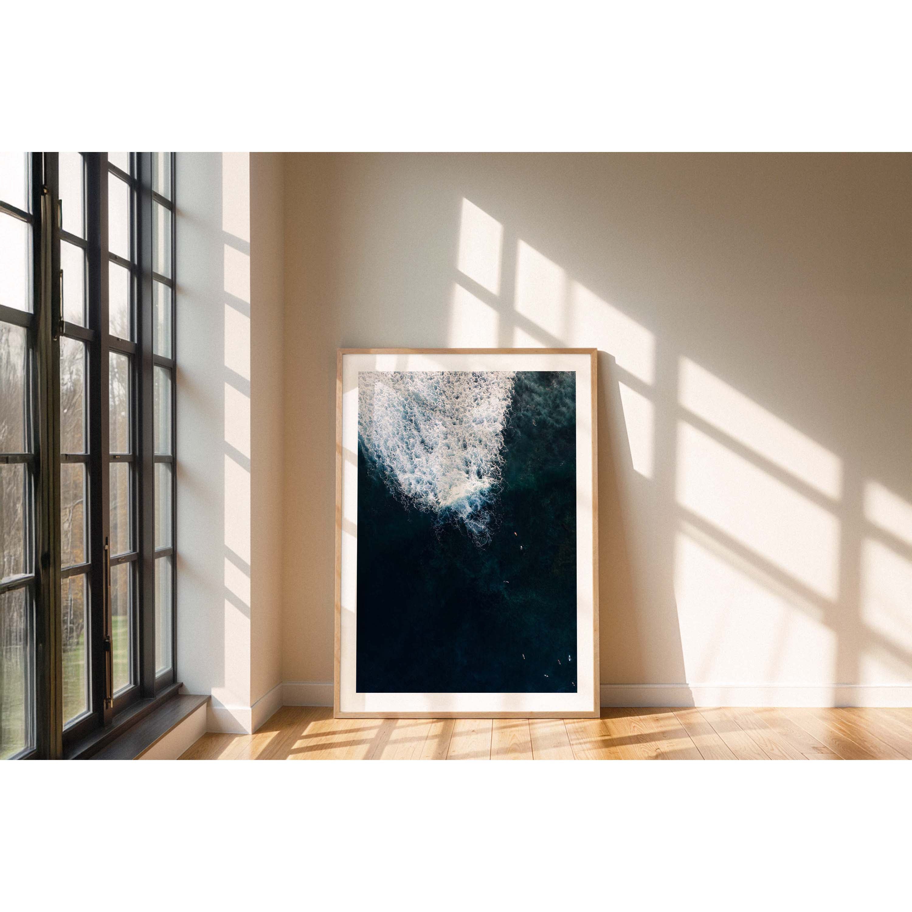 Vertical aerial photo of surfers in deep blue water at Yallingup beach, Western Australia. Perfect for a coastal home or beach house. Original fine art photography, available as prints and framed wall art.