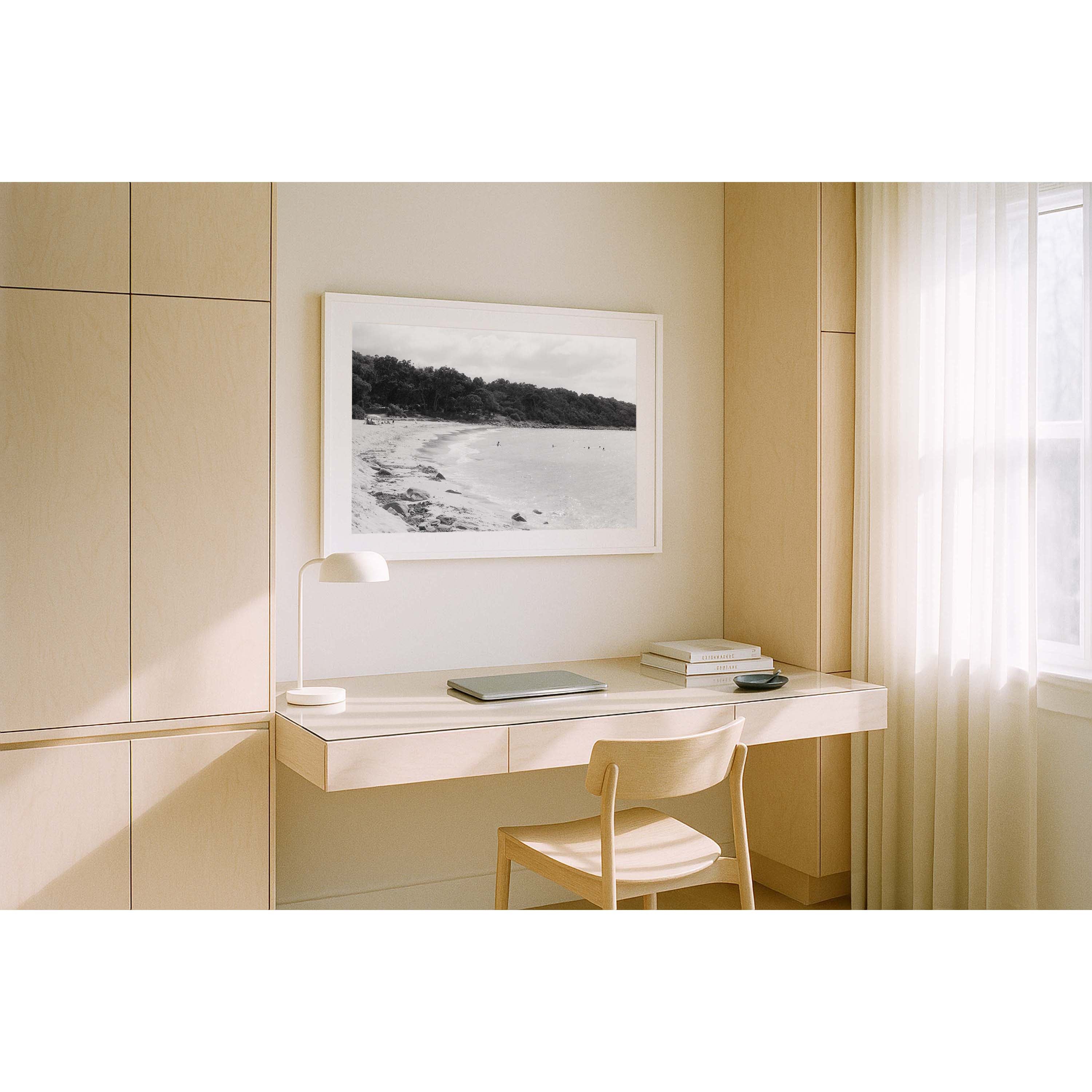 Black and white photo of Meelup beach in Western Australia's south west with people in the ocean and the bush wrapping around the coastline. Shot on film with a nostalgic, vintage feel. Available framed in black, white or oak.