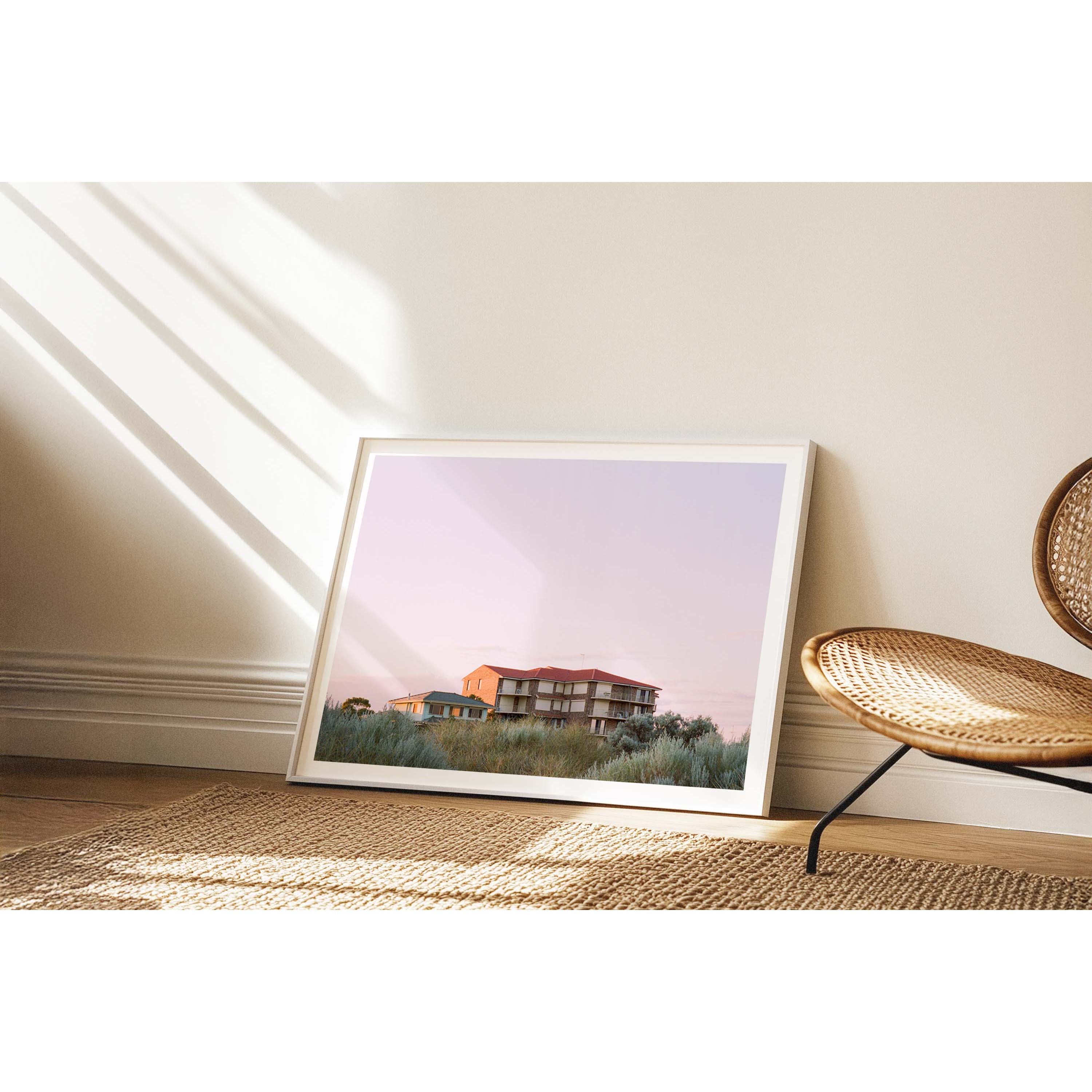 Horizontal photo of the top of a brick 80s block of units in Mandurah, Western Australia. Most of the photo is a soft, lavender sky with silver green bushes in the foreground. Original fine art photography, available as prints and framed wall art.