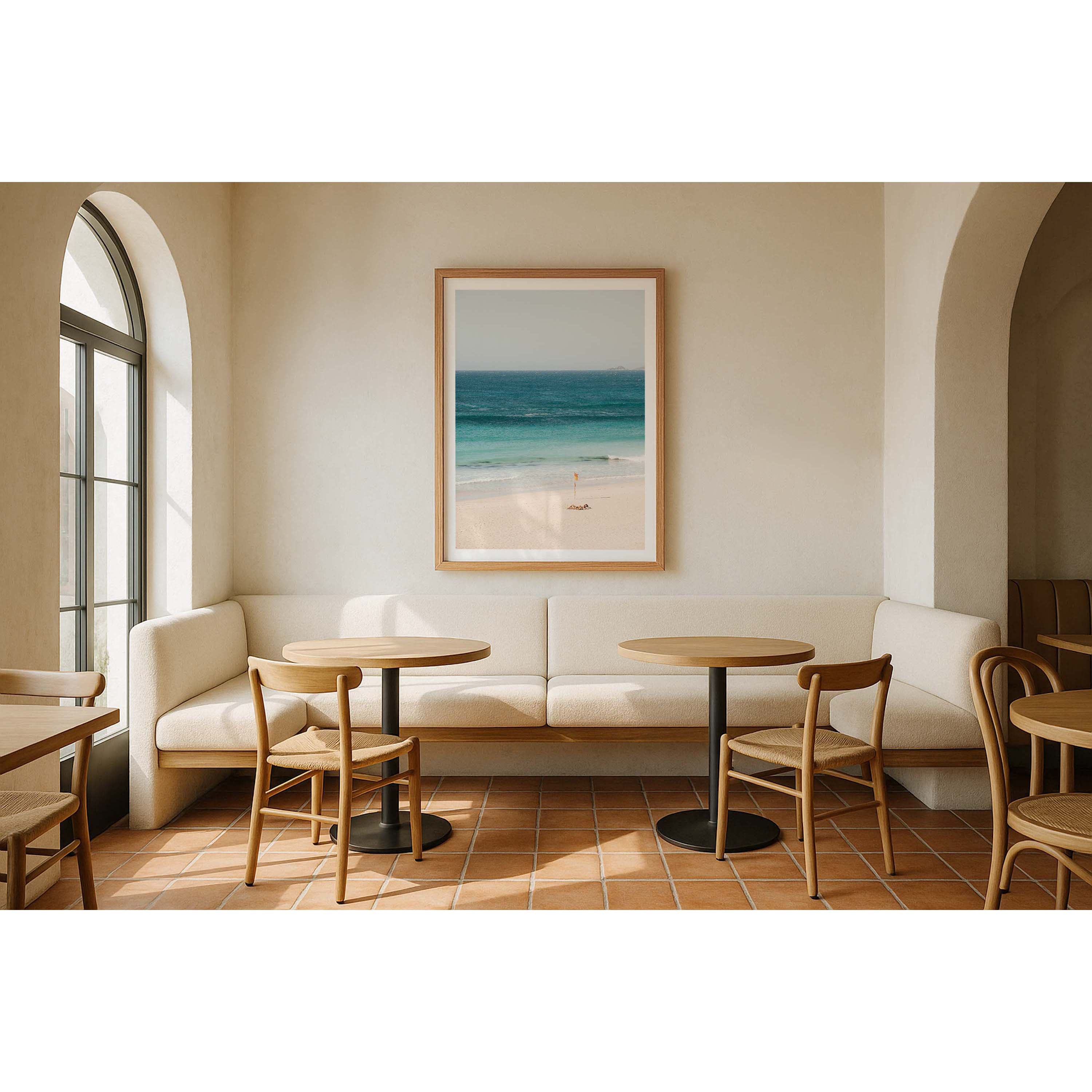 Colour photo of two girls sunbathing on Smiths Beach in Western Australia, next to the lifeguard red and yellow flag as the ocean gently rolls in. Available framed in black, white and oak.