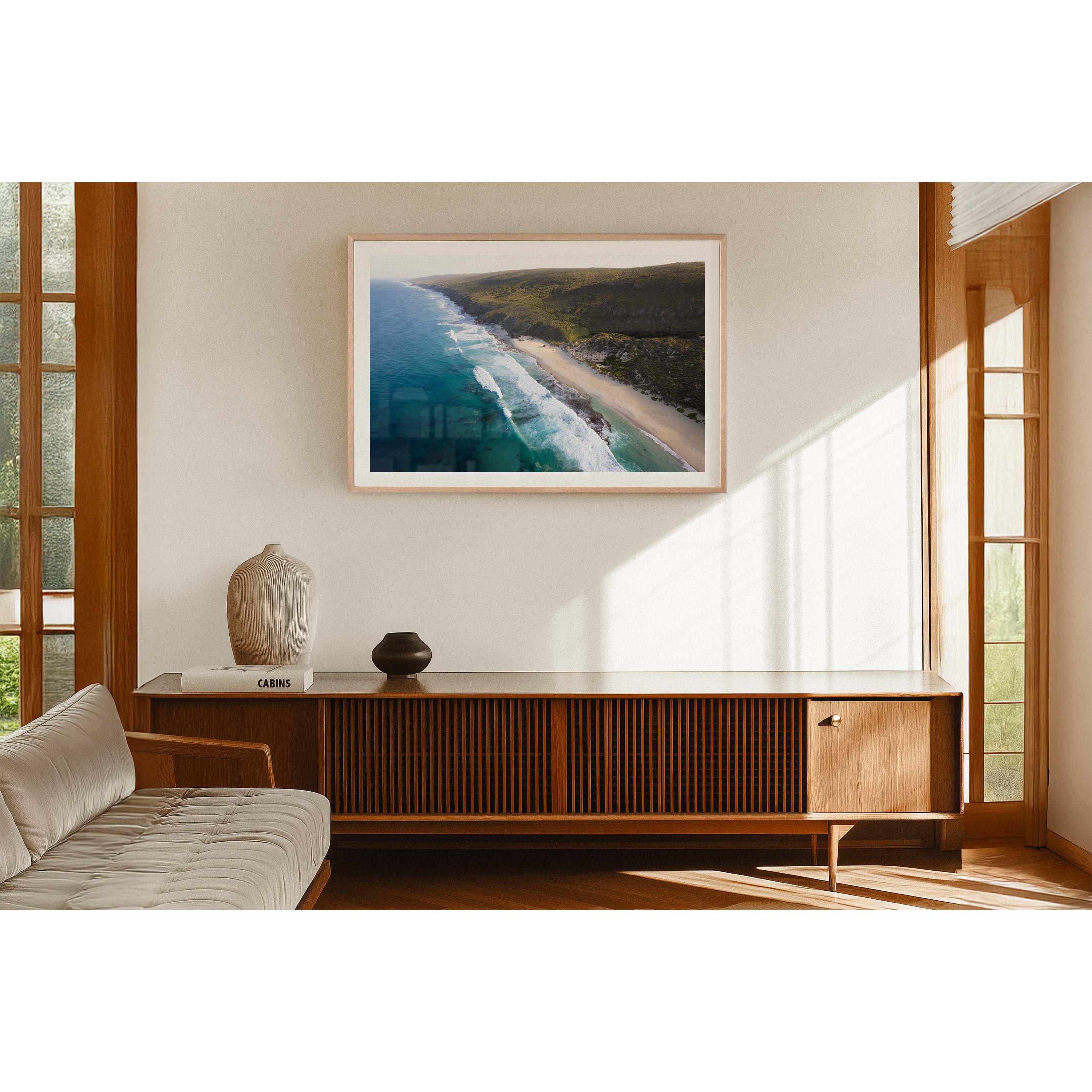 Horizontal drone photo of the far end of Yallingup Beach with the waves rolling in to the white sand and the bushland stretching into the distance. Original fine art photography of Western Australia, available as prints and framed wall art. Perfect for a coastal home or beach house.