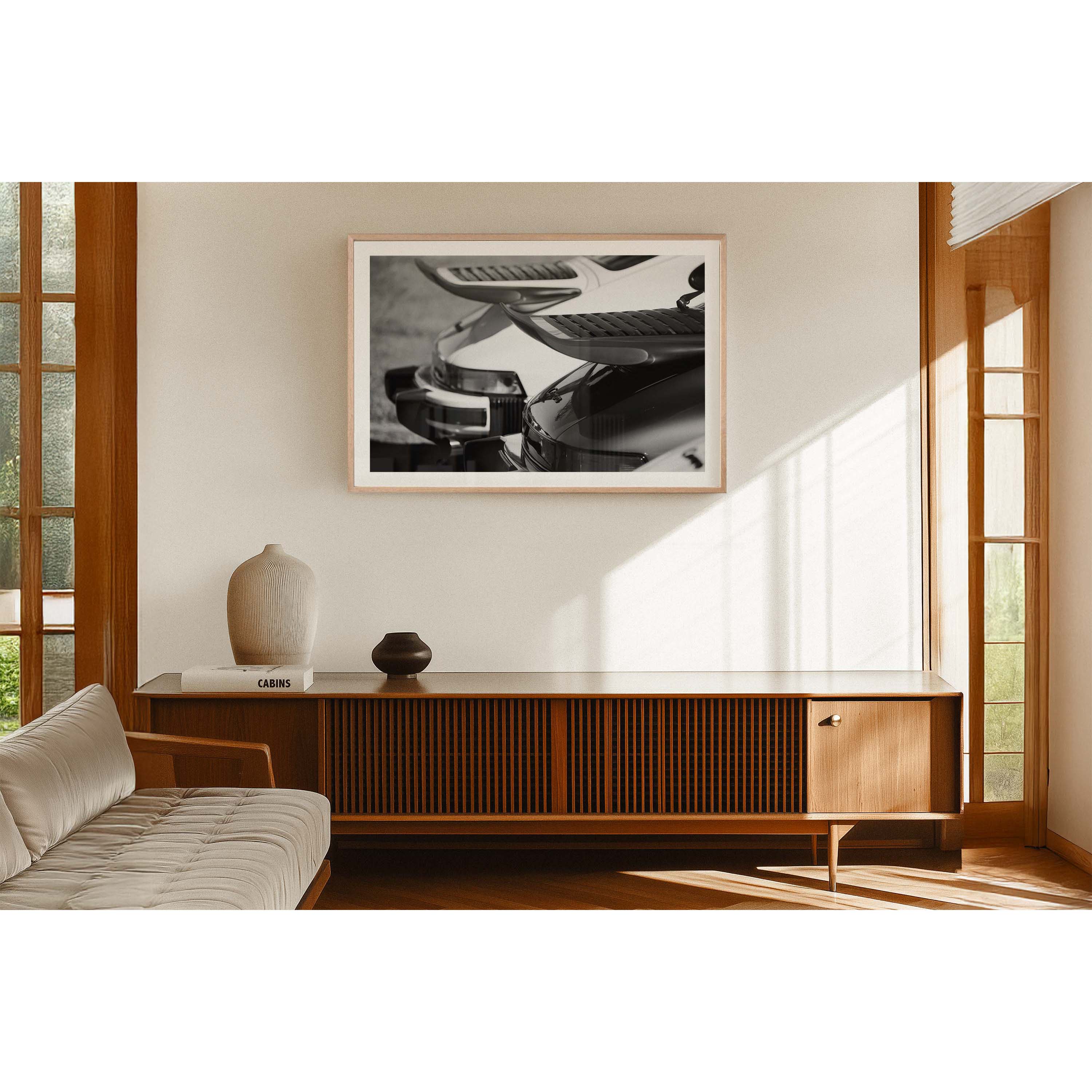 Black and white photo of the back of two Porsche 911s showing the iconic whale tail spoilers. Fine art photography prints, available framed in black, white or oak.