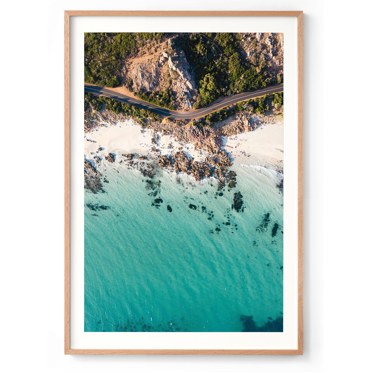 Vertical drone photo taken of the road between Meelup beach and Bunker Bay in Western Australia near Yallingup. The road curves softly between the white sandy beach of Eagle Bay and the bush. Perfect for the modern beach home, coastal interior or relaxed space. Original fine art photography, available as prints and framed wall art.