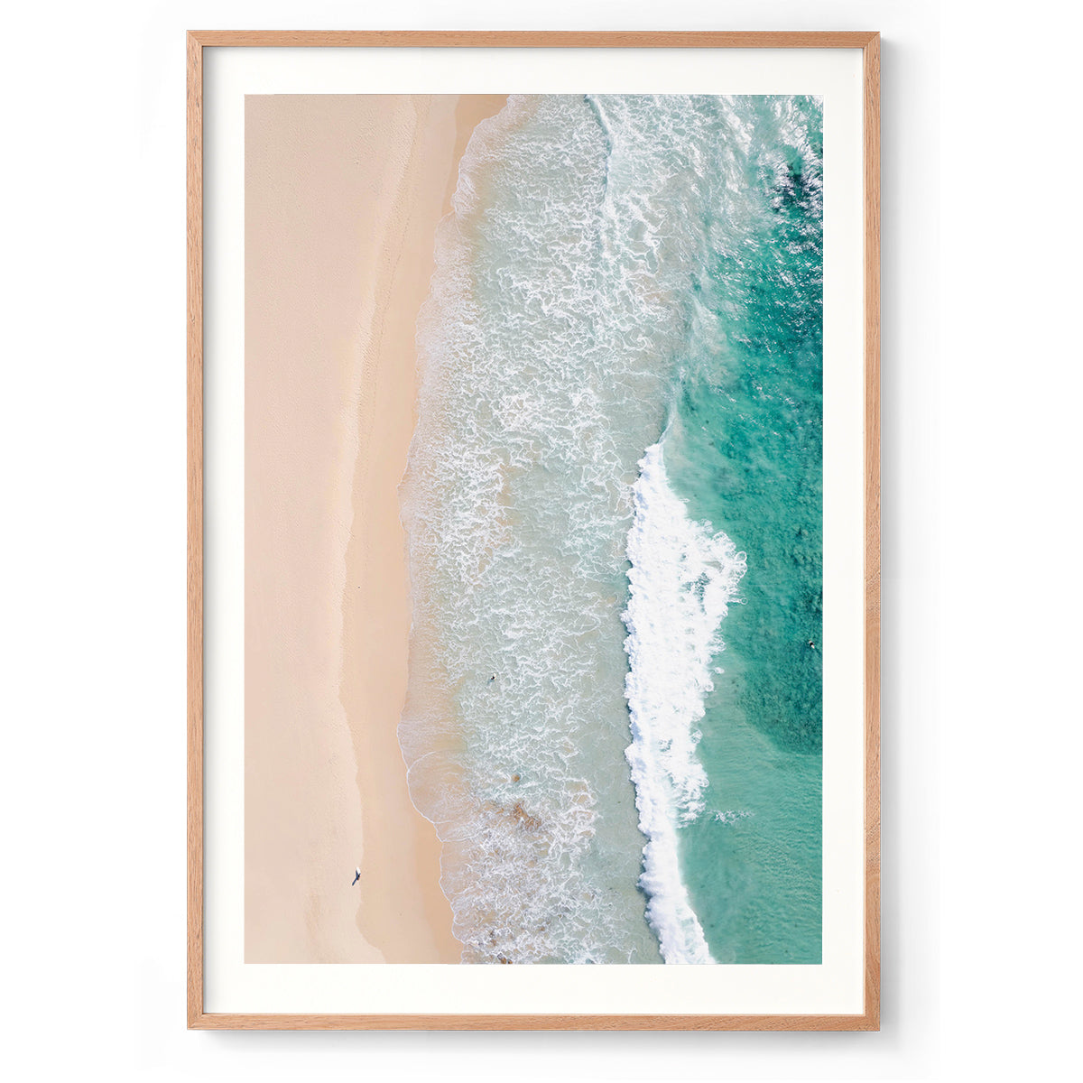 Vertical drone photo of Smiths Beach in Western Australia. It is very minimalist with the white sand down the left side and the turquoise water crashing in on the right. There is a tiny surfer walking along the beach. Original fine art photography, available as prints and framed wall art. Perfect for your coastal living room, dining room, bedroom or home office. Shipped free worldwide.