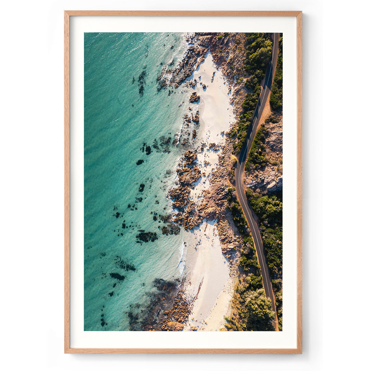 Vertical drone photo taken of the road between Meelup beach and Bunker Bay in Western Australia near Yallingup. The road curves softly between the white sandy beach of Eagle Bay and the bush. Perfect for the modern beach home, coastal interior or relaxed space. Original fine art photography, available as prints and framed wall art.