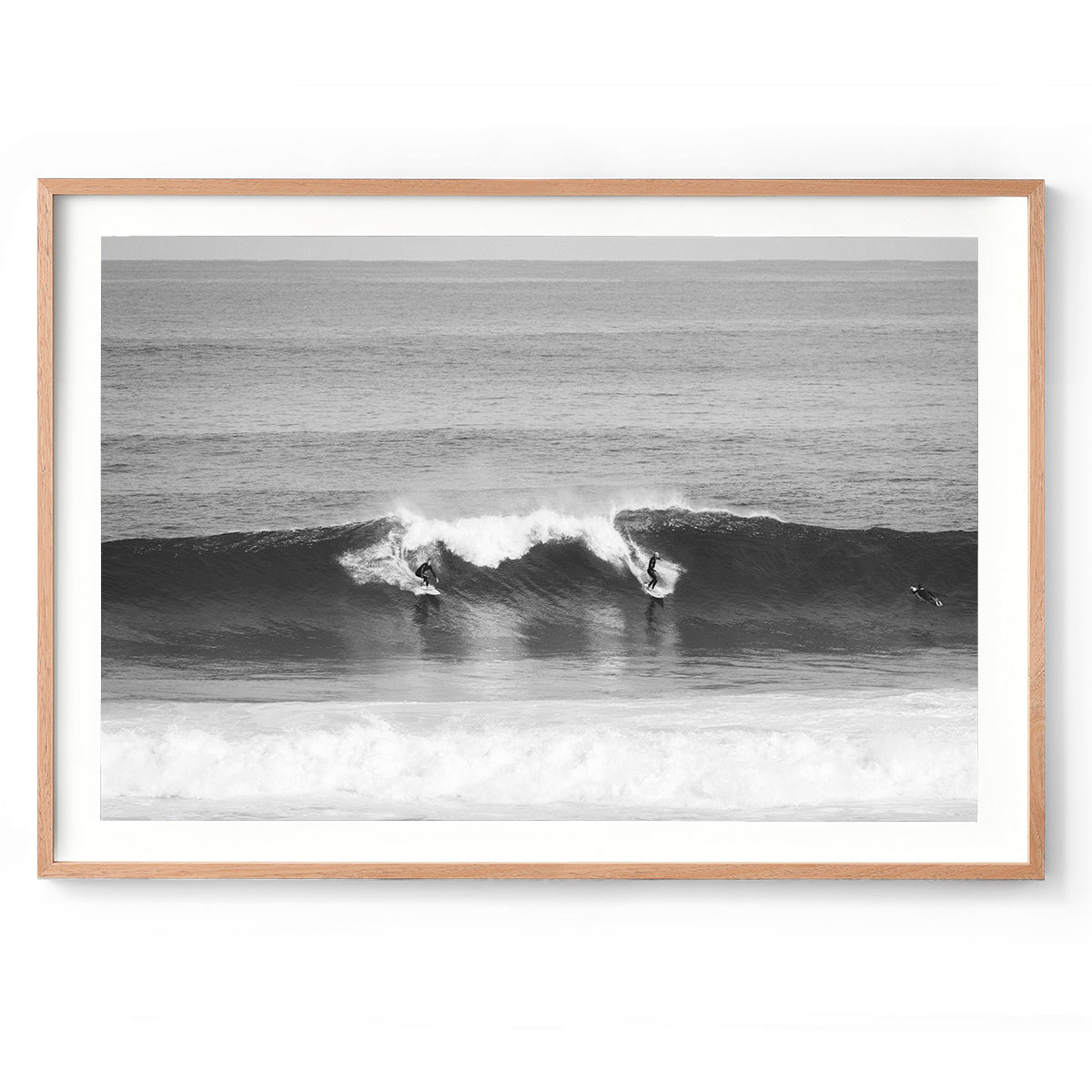 Black and white photo of two surfers riding a wave at Surfer's Point in Margaret River, Western Australia. Fine art photography prints, available framed in black, white or oak.