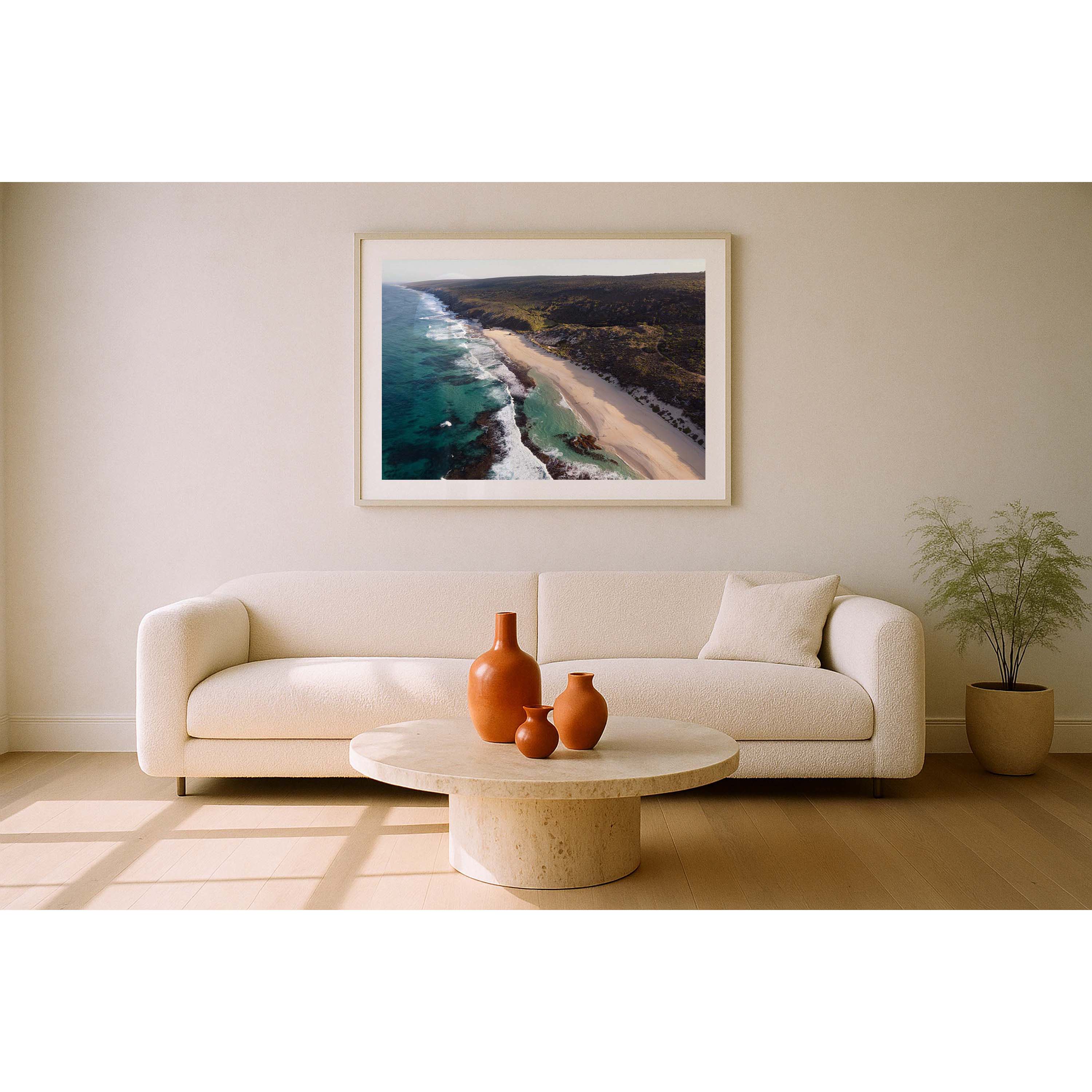 Horizontal drone photo of the far end of Yallingup Beach with the waves rolling in to the white sand and the bushland stretching into the distance. Original fine art photography of Western Australia, available as prints and framed wall art. Perfect for a coastal home or beach house.