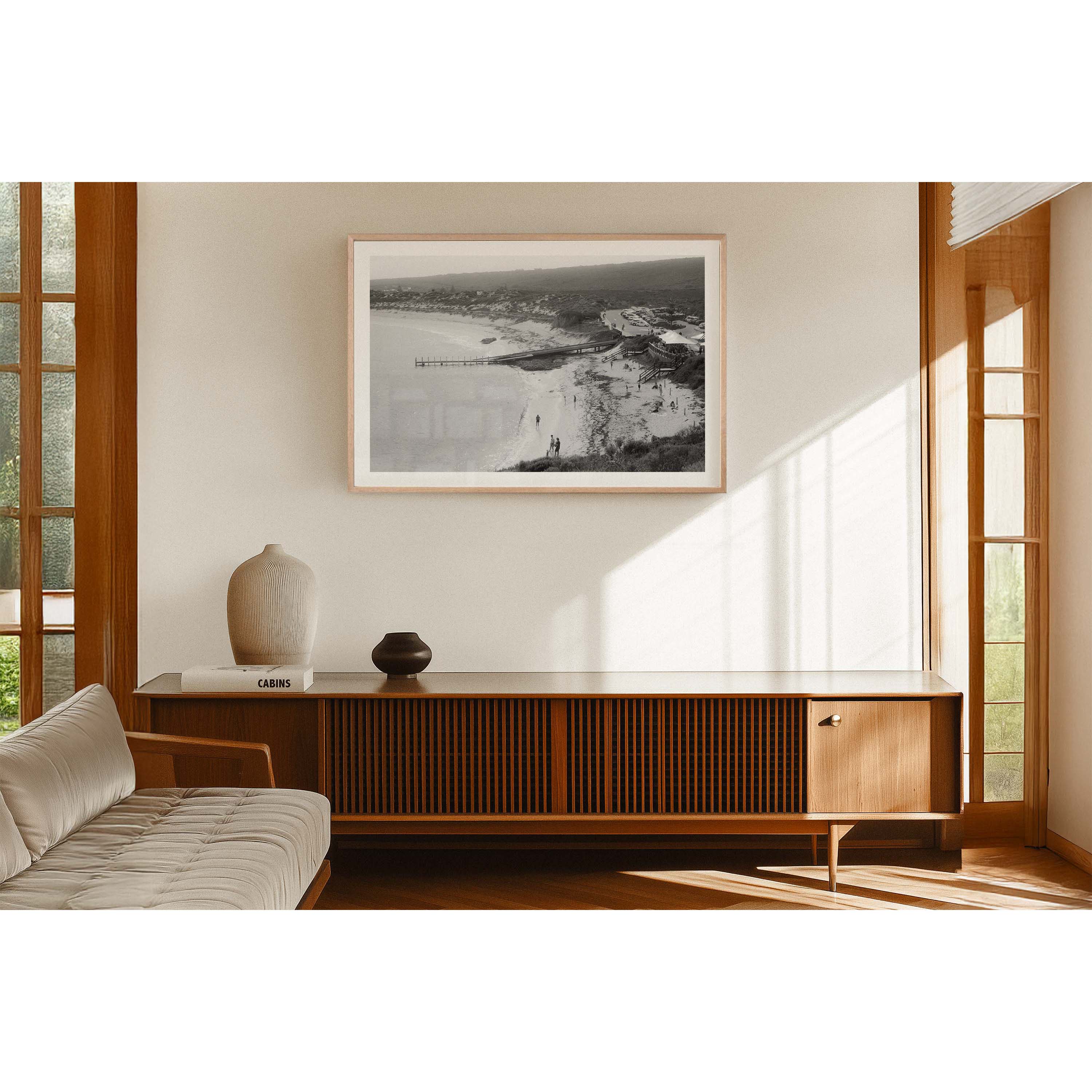 Black and white photo of Gnarabup beach in Margaret River, Western Australia. It shows the jetty and White Elephant Cafe and people on the sand, it has a nostalgic feel to it - shot on film.
