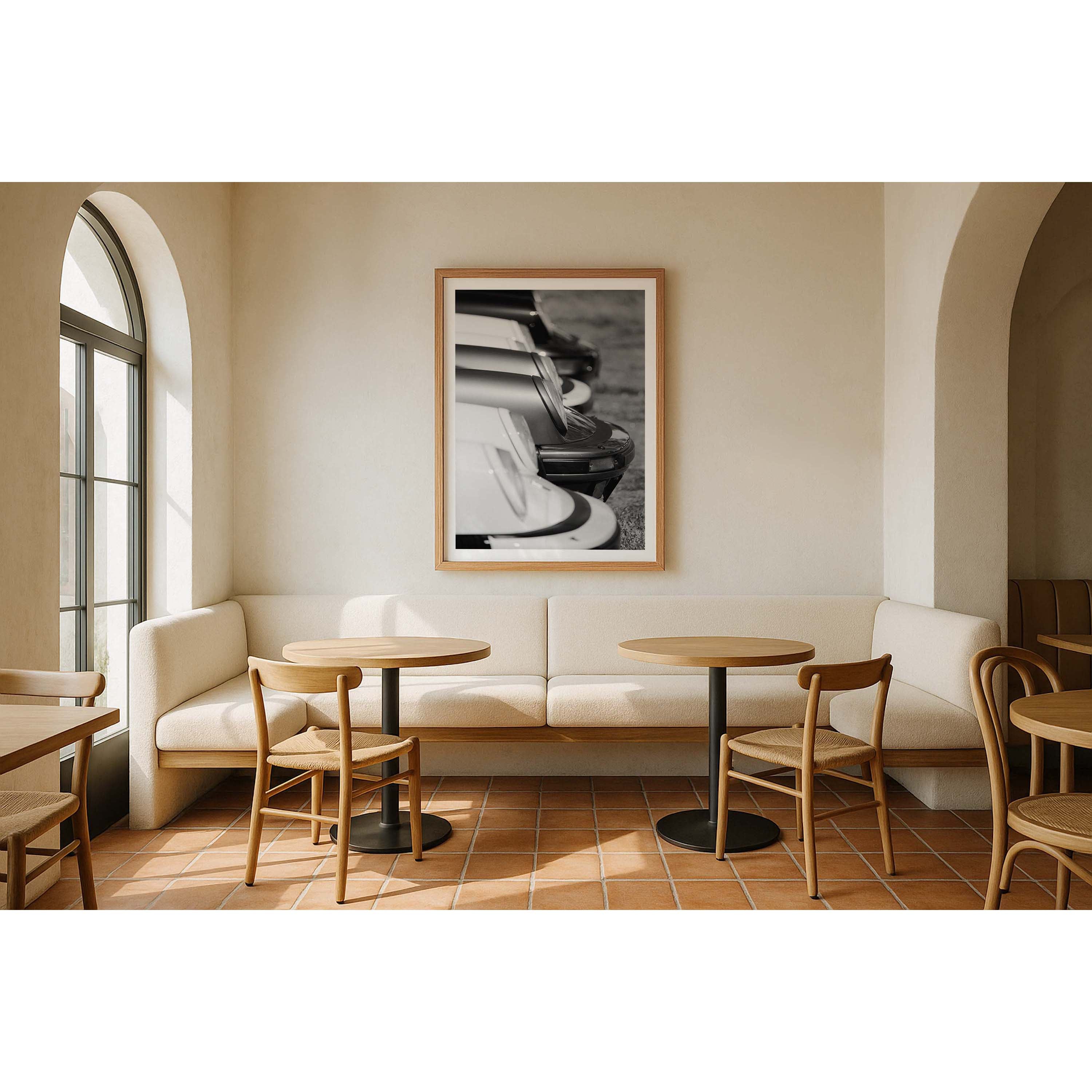 Vertical black and white photo of the front of multiple Porsche 911s from the side all lined up showing just the iconic round headlights and bumpers. Fine art photography prints, available framed in black, white and oak.