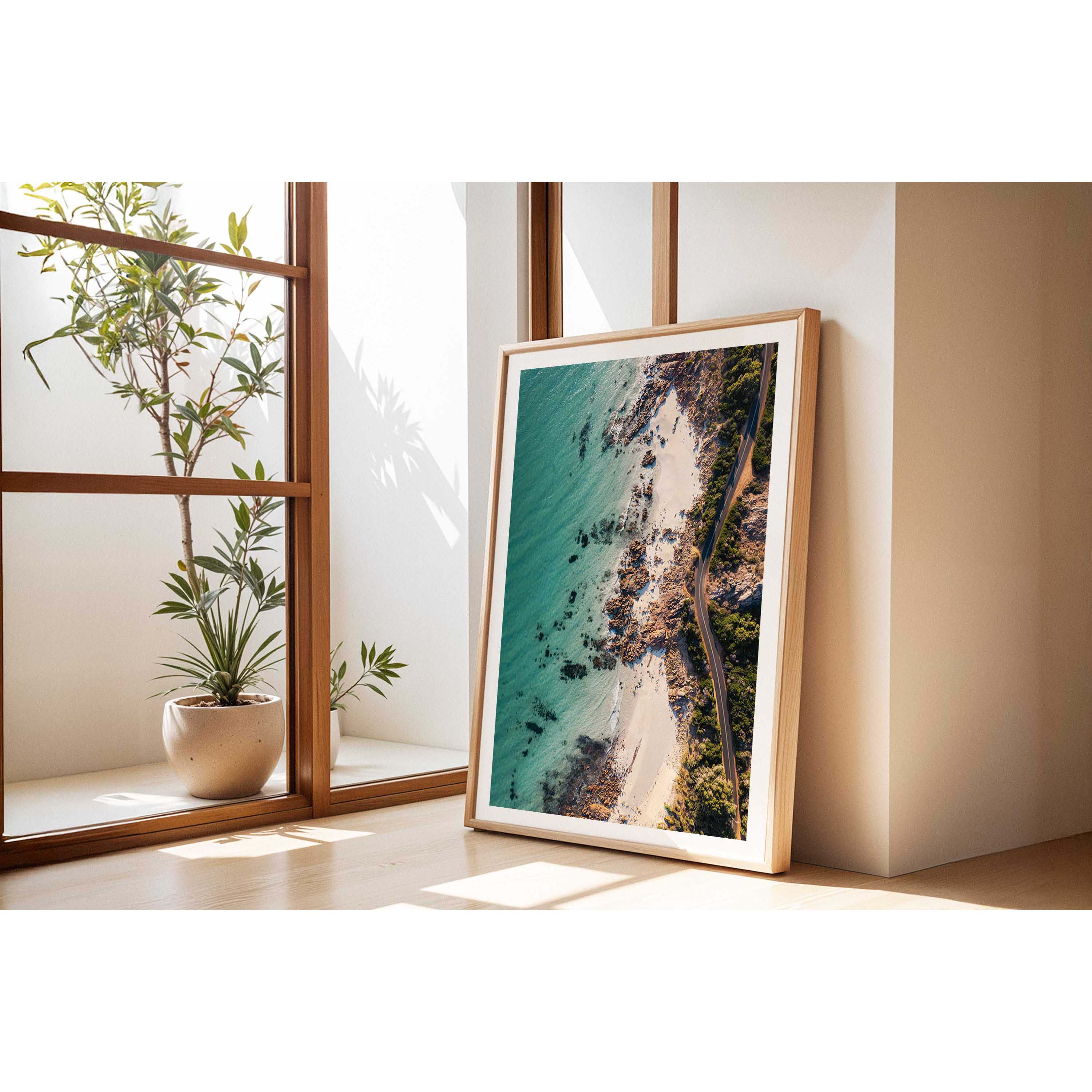 Vertical drone photo taken of the road between Meelup beach and Bunker Bay in Western Australia near Yallingup. The road curves softly between the white sandy beach of Eagle Bay and the bush. Perfect for the modern beach home, coastal interior or relaxed space. Original fine art photography, available as prints and framed wall art.