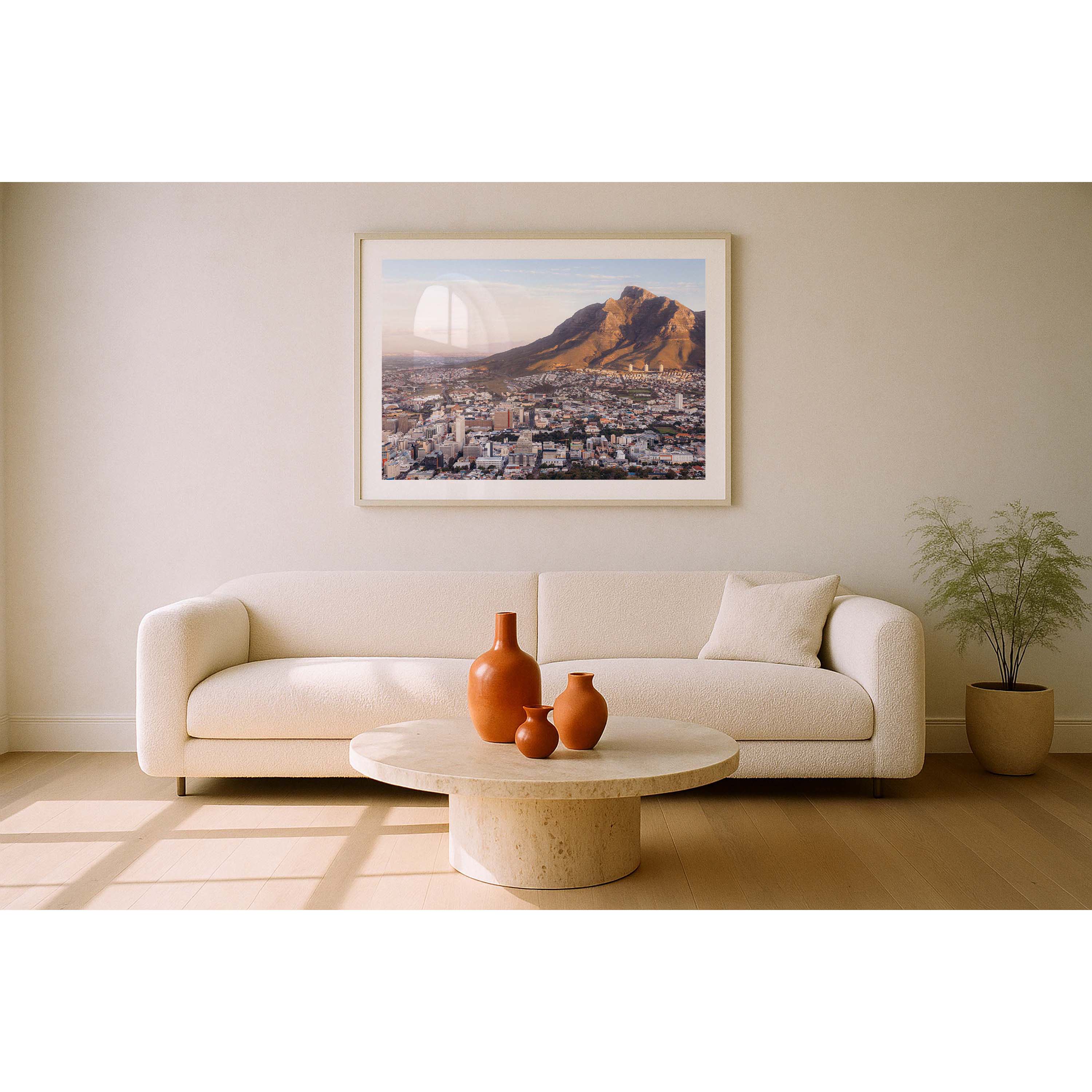 Framed photo of Table Mountain in Cape Town, South Africa. The city is in the foreground and the mountain is hit with golden light at sunset. Fine art photography prints, available framed in black, white or oak.